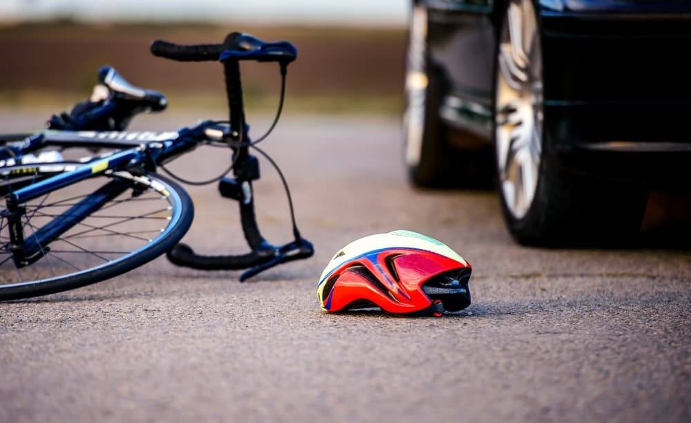 Traffic accident bicycle helmet on road after car hit a cyclist