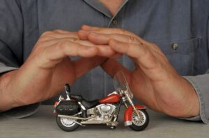 A person displaying a tiny motorbike.