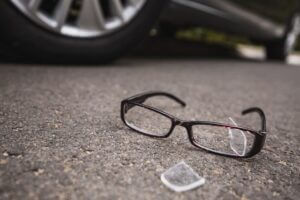 Glasses on ground next to car