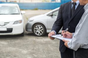 Insurance adjuster discussing damages after car accident