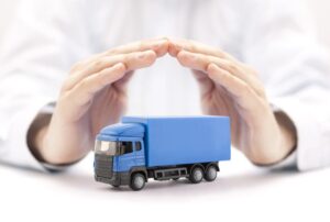 Blue truck miniature covered by hands