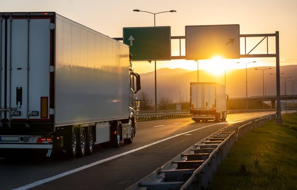 Rear angle view of delivery cargo trucks on the road