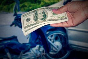 Dollars in hands for damages in motorcycle accident 