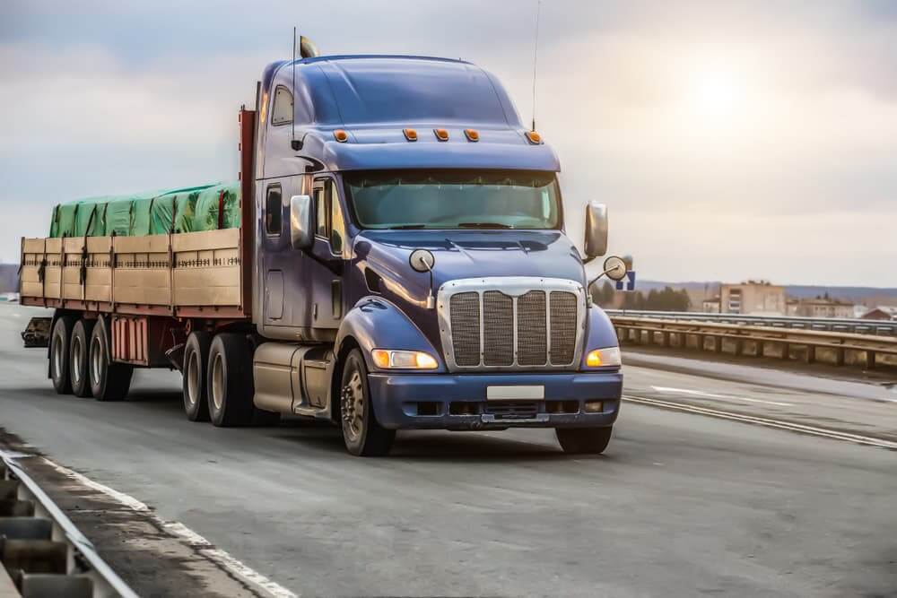 A truck moving on a country highway