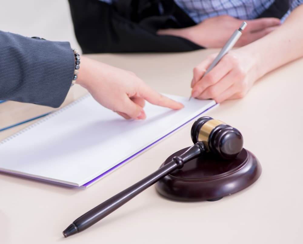 An injured employee consulting a lawyer for guidance on insurance claims.