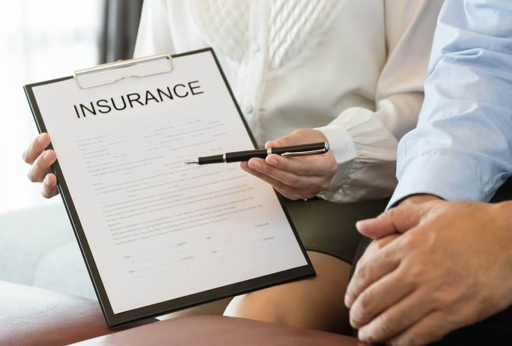 The image of an insurance agent explaining the details of an insurance policy to a policyholder.