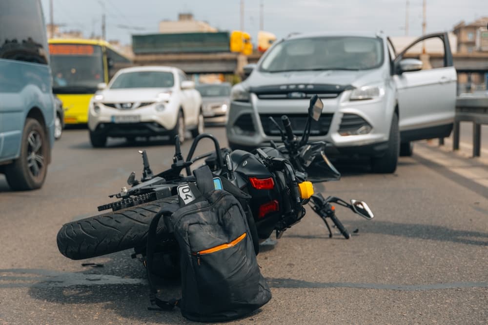 The motorcycle lies on the sidewalk after a ride. Collisions with another vehicle