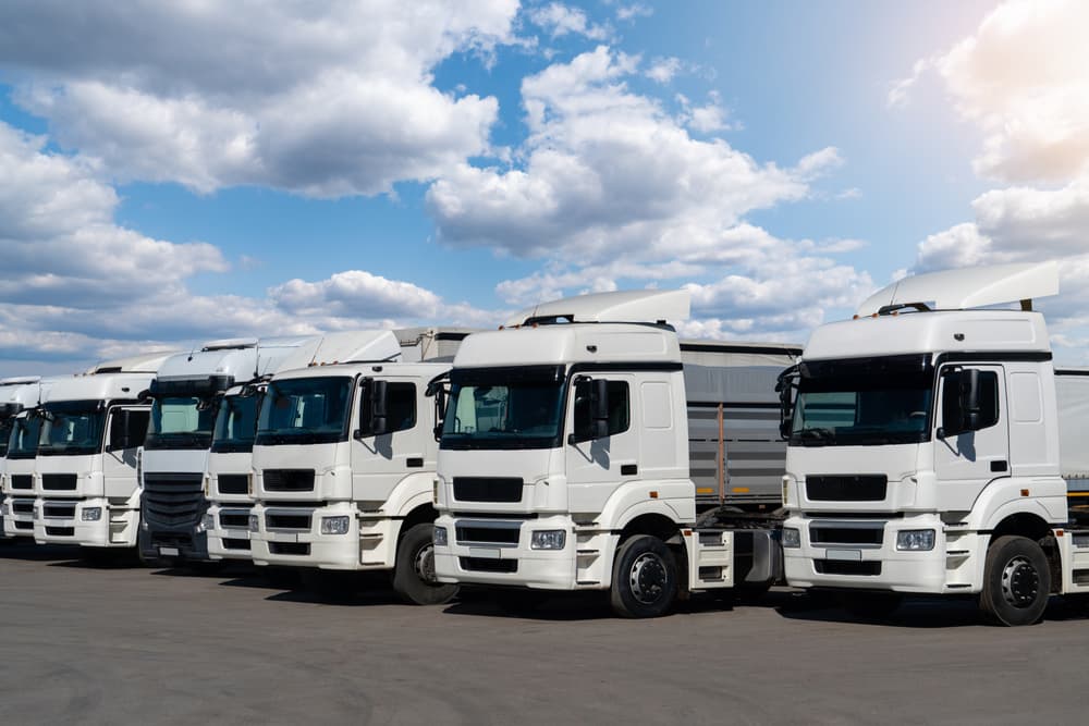 Semi trucks are parked in a row