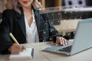 Lawyer scheduling a date for consultation on laptop's calendar 