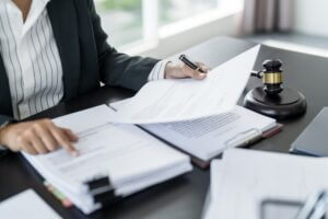 Personal injury lawyer with gavel and lawbook at desk, symbolizing legal support to protect clients' rights after an accident. 