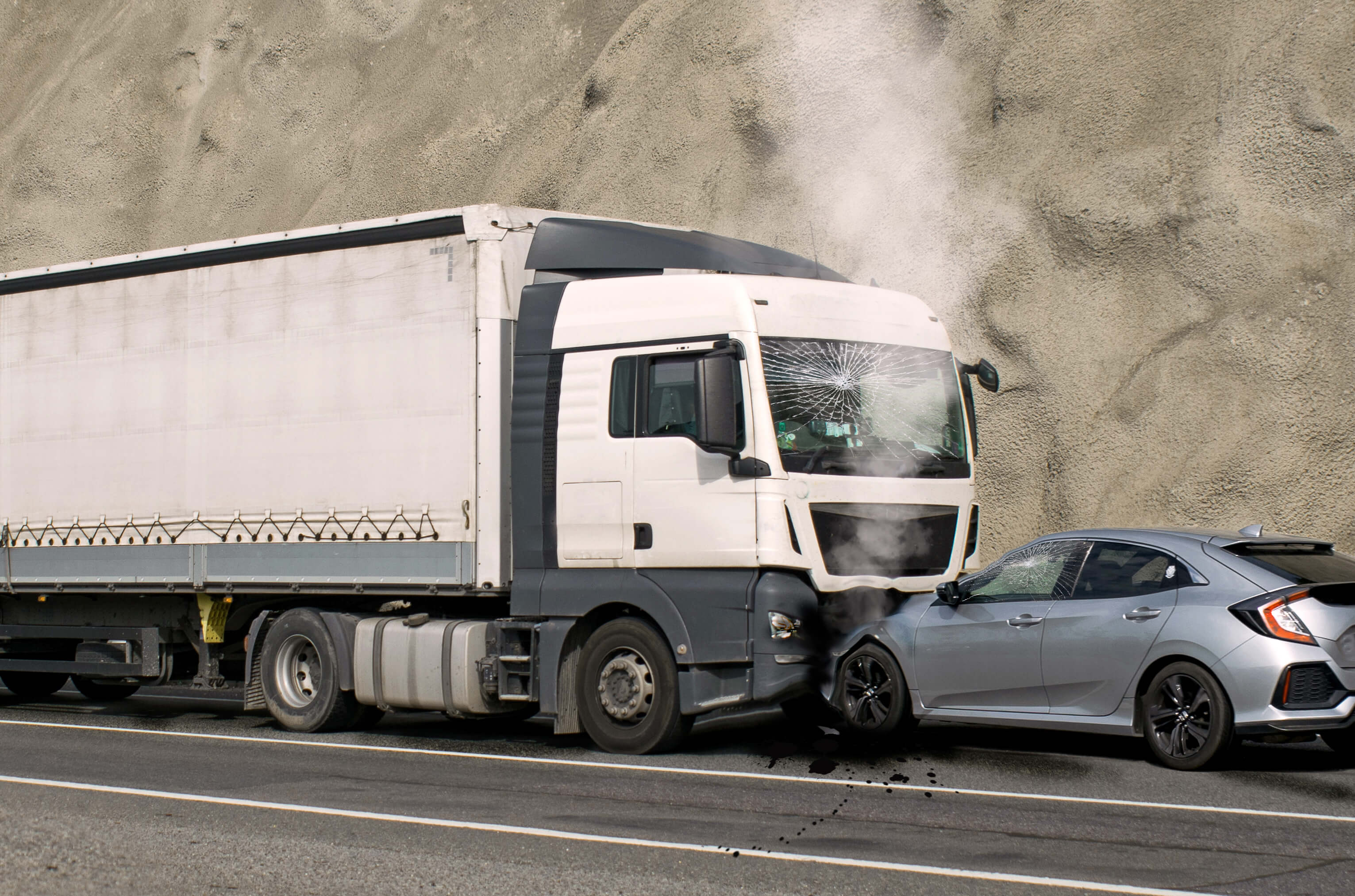 Semi-truck and car collision on highway with vehicle damage and smoke. Semi-truck and car collision on highway with vehicle damage and smoke.